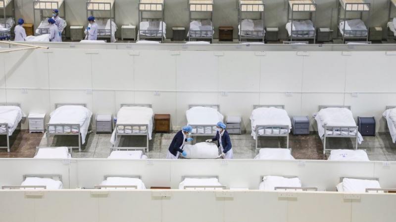 Staffers setting up beds at a makeshift hospital in Wuhan, China