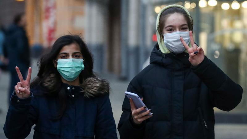 Young people in face masks amid COVID-19 pandemic.