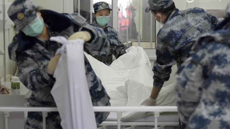 Chinese military medics prepare hospital beds in Wuhan