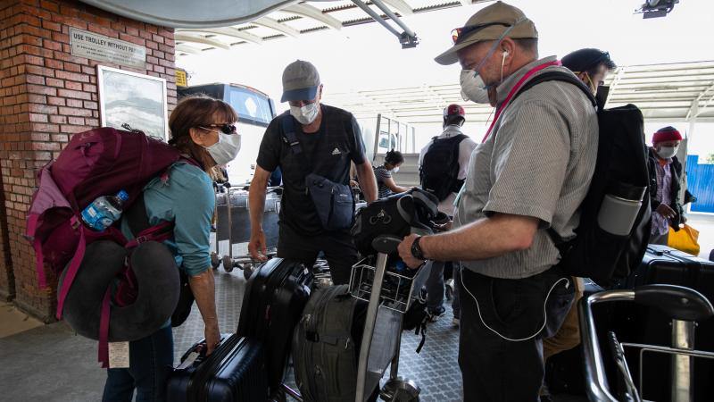  American citizens wearing protective masks stranded during the lockdown amid Coronavirus outbreak. 