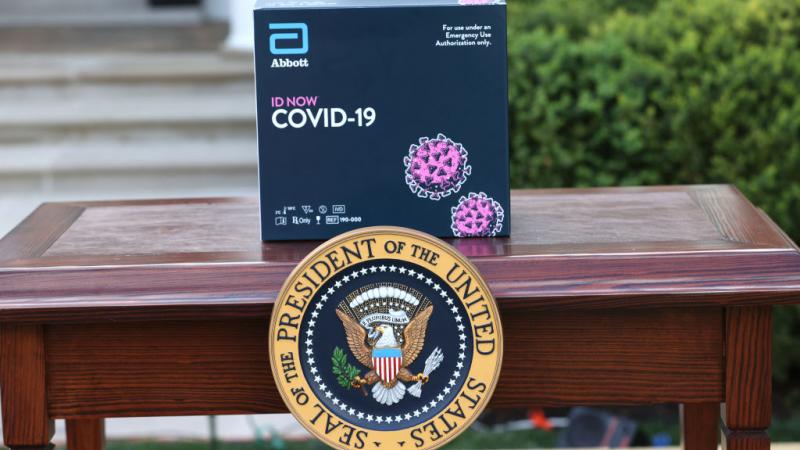 ID NOW rapid response coronavirus tests from Abbott Labs on display at a White House press briefing