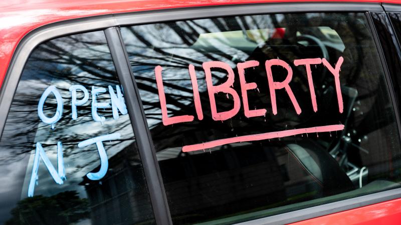 Protest sign on a car window to reopen New Jersey at the State Capitol.