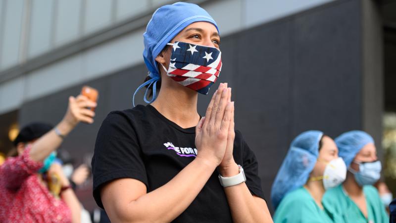 A medical worker stands outside NYU Langone Health