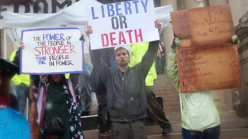 Demonstrators hold a rally in front of the Michigan state capital building to protest the governor's stay-at-home order.