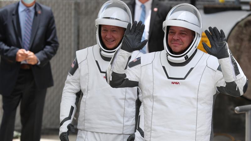 NASA astronauts Bob Behnken (R) and Doug Hurley (L) on their way to the SpaceX Falcon 9 rocket.