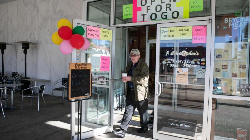 A patron leaves a restaurant in Decatur, Georgia, 4/27