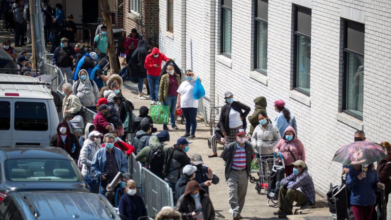 Brooklyn residents wait in line for food distribution