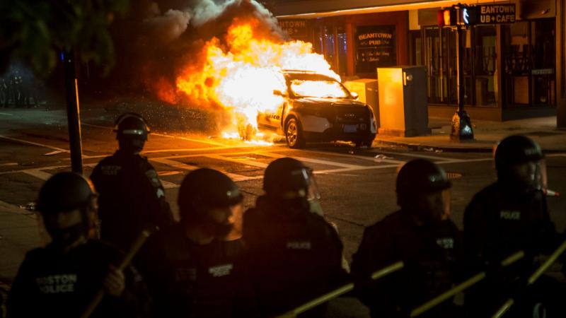 A car set aflame in Boston