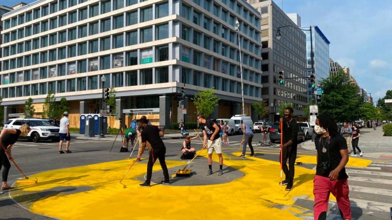 Activists painting the giant display