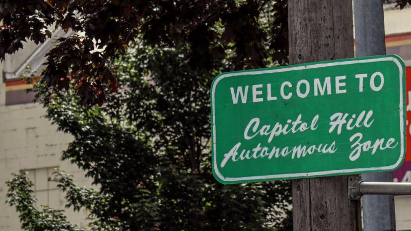 A sign marking the border of the "Capitol Hill Autonomous Zone" in Seattle, Washington