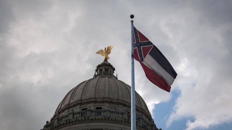 Mississippi state flag in front of state capitol building on June 28, 2020