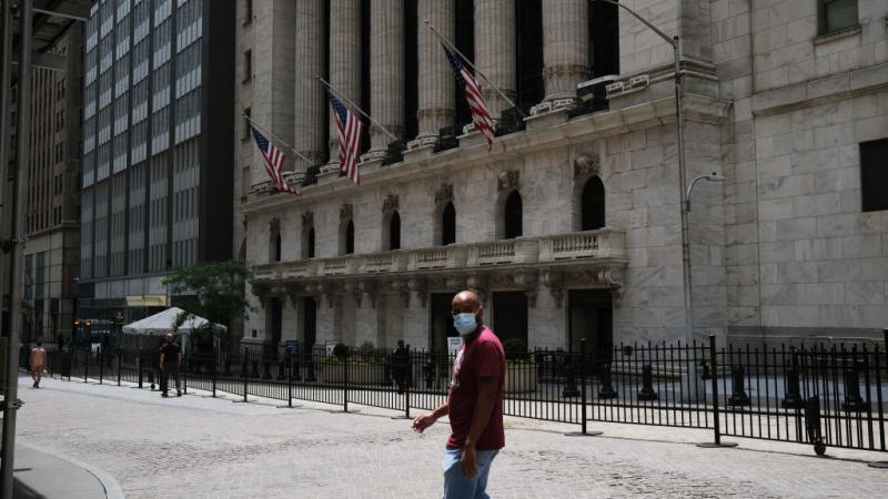 Person walking near New York Stock Exchange on June 15, 2020