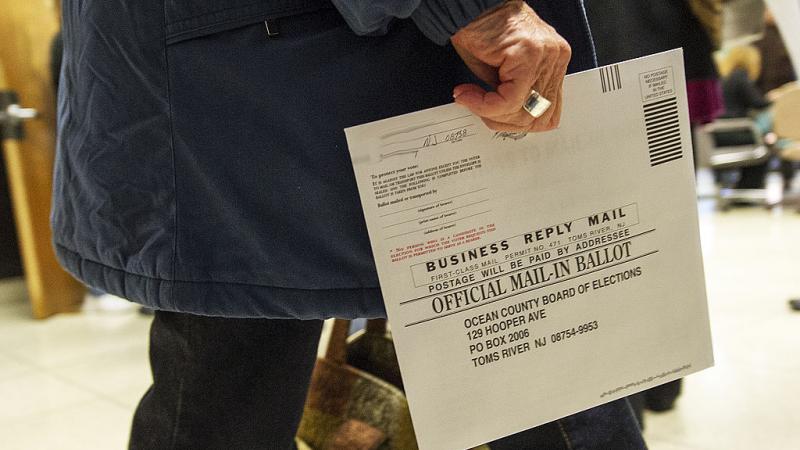 A New Jersey voter with a mail-in ballot