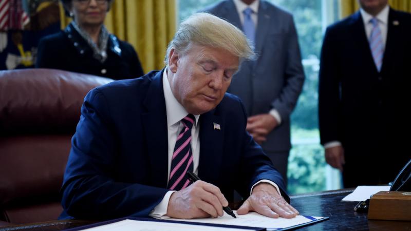 President Donald Trump signs the Paycheck Protection Program and Health Care Enhancement Act