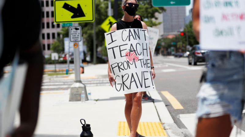 A teacher protesting against reopening in Tampa, FL