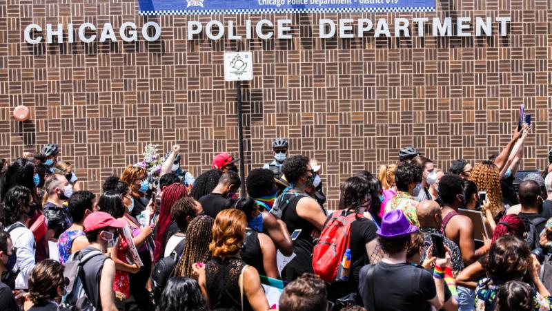 Chicagoans gather in front of a city Police Department 
