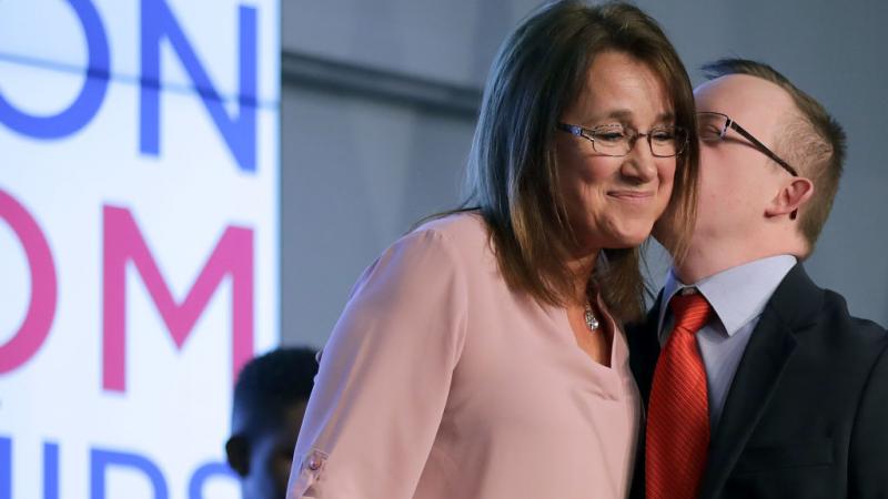 Tera Myers and her son Samuel addressing an event to discuss the proposal for Education Freedom Scholarships 