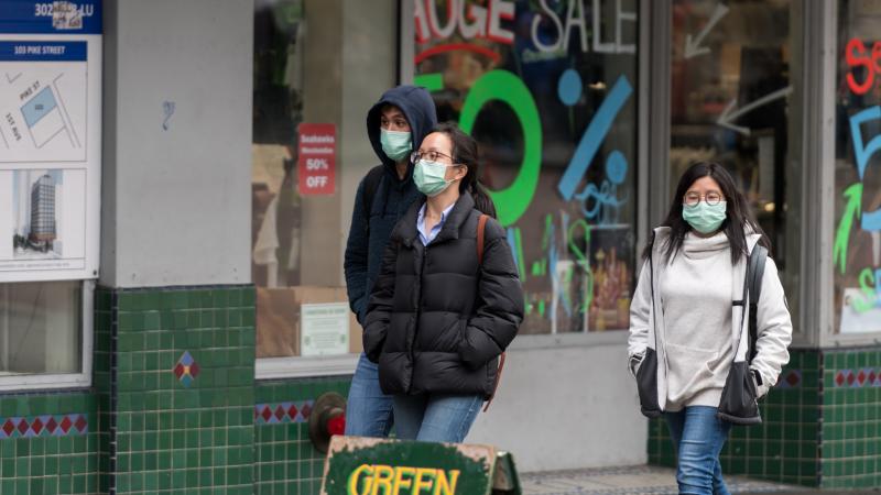 Residents of Seattle, Washington wear masks