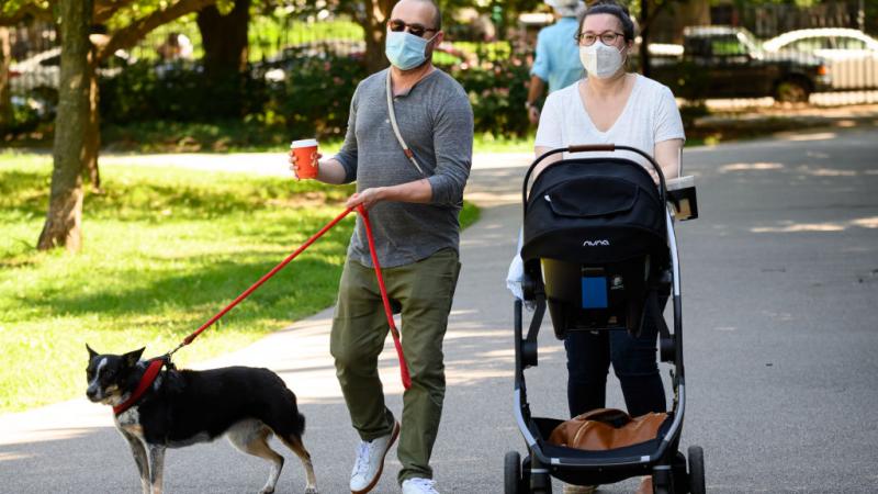 Americans in New York wearing face masks while walking outdoors