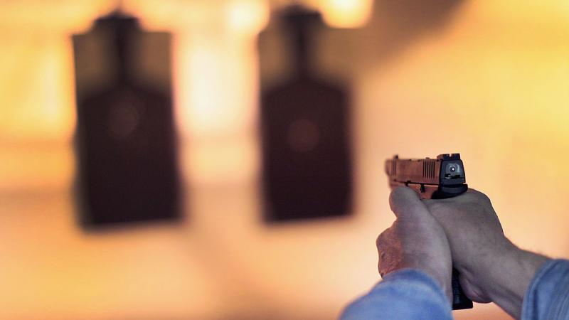 Person pointing a gun at a target in Illinois in 2014