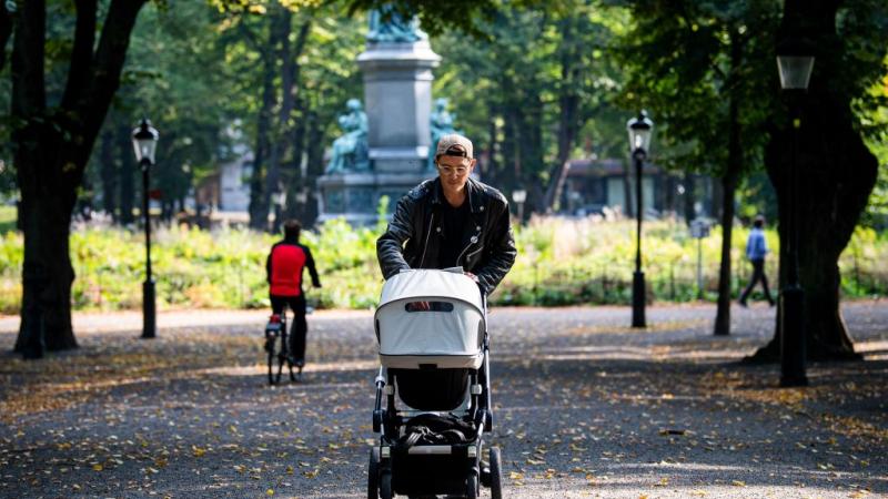 A man pushing a stroller in Sweden