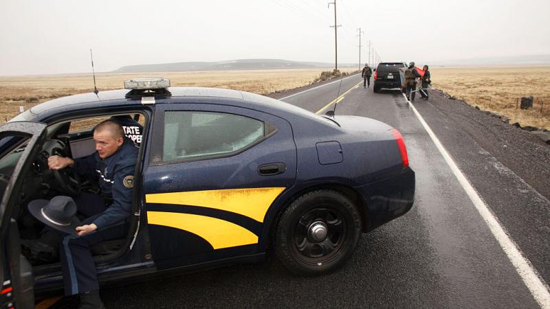 State trooper getting out of his car.