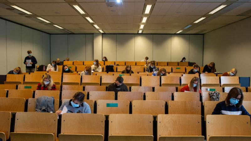 Students wear masks and sit apart for class lecture 