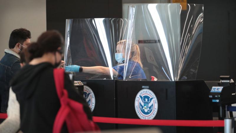 TSA agent screens someone at O'Hare International Airport on Oct. 19, 2020