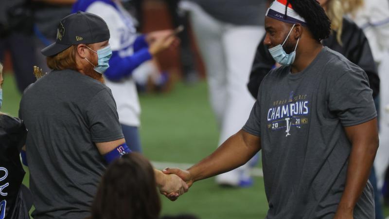 Justin Turner (left) shakes teammate Pedro Baez's hand after big win.