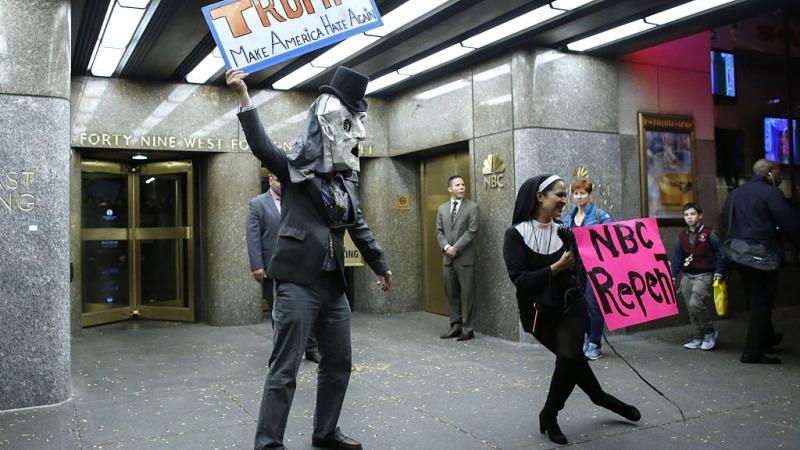 People protest in front of NBC studios while they are calling for the network to rescind the invitation to Donald Trump to host Saturday Night Live show on November 4, 2015 