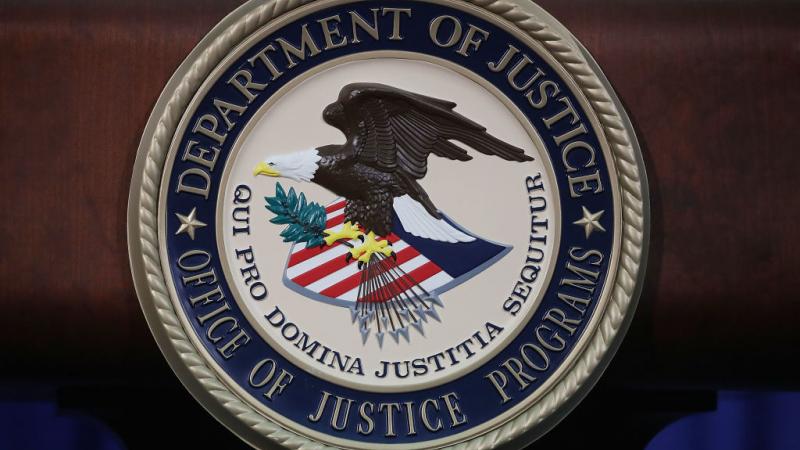DOJ seal on a lecturn in 2017