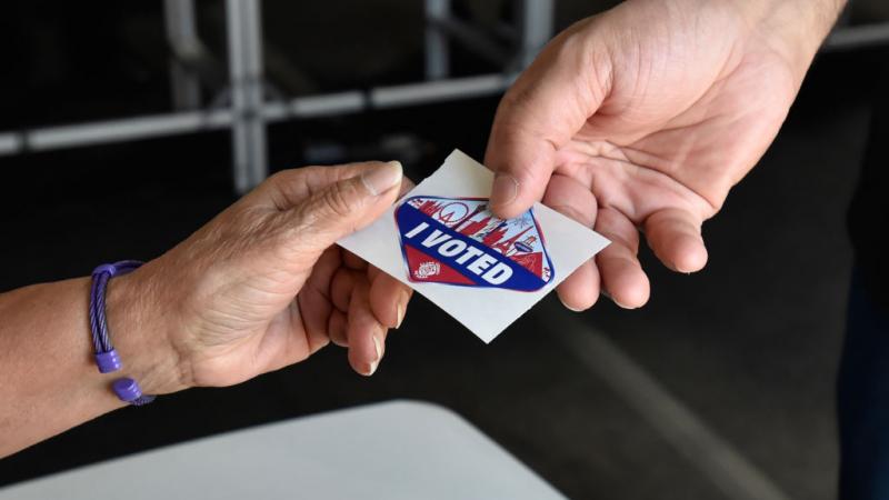 Voter getting a Las Vegas Strip-themed "I Voted" sticker in November 2018