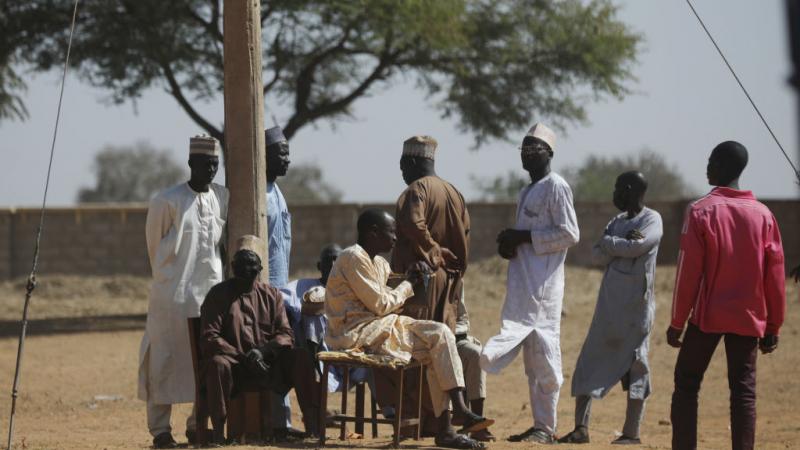 Parents wait outside the Government Science where gunmen abducted students in Kankara, in northwestern Katsina state, Nigeria