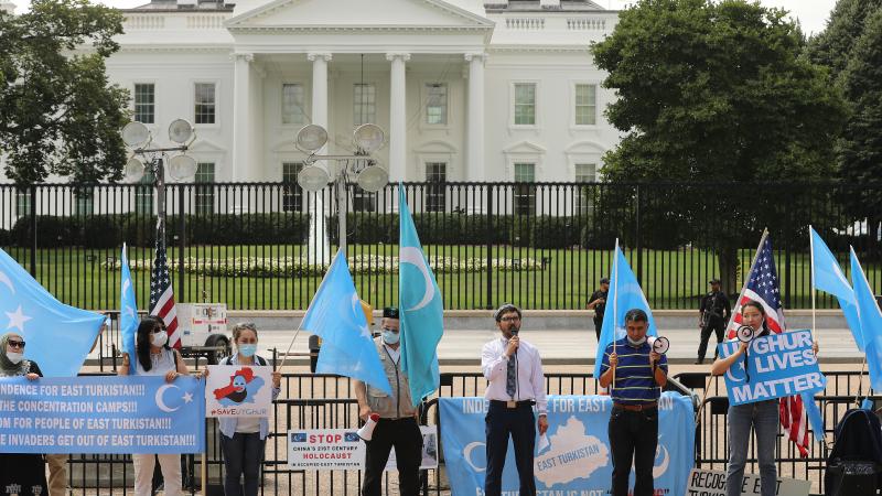 Supporters and members of the East Turkistan National Awakening Movement, including group founder Salih Hudayar (C), rally outside the White House to urge the United States to end trade deals with China and take action to stop the oppression of the Uyghur and other Turkic peoples August 14, 2020 in Washington, DC.
