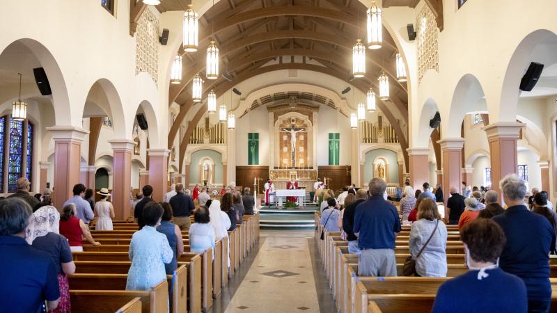 Worshippers stand socially distanced with masks on during an indoor mass held by San Francisco's Archbishop Salvatore Joseph Cordileone at the Church of Saint Raphael in San Rafael, Calif. Saturday, October 17, 2020.