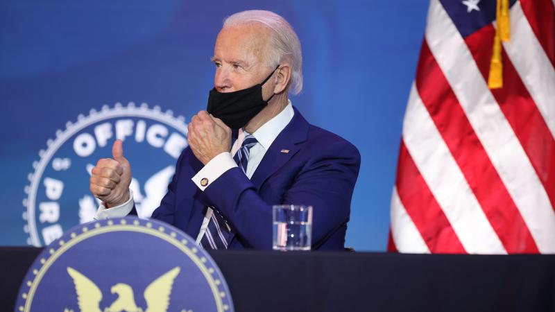 U.S. President-elect Joe Biden gives the thumbs-up as he adjusts his mask after he announced U.S. Army (retired) General Lloyd Austin as his choice to be Secretary of the Department of Defense at the Queen Theatre on December 09, 2020 in Wilmington, Delaware.