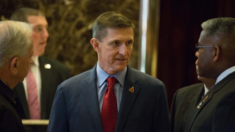 Retired Lt. Gen. Michael T. Flynn, the choice of President-elect Donald J. Trump for national security adviser, talks with colleagues at Trump Tower on December 5, 2016 in New York City. 