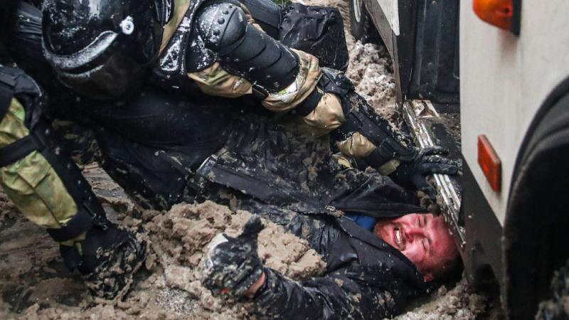 Riot police detain a protester at a rally in support of Russian activist Alexei Navalny