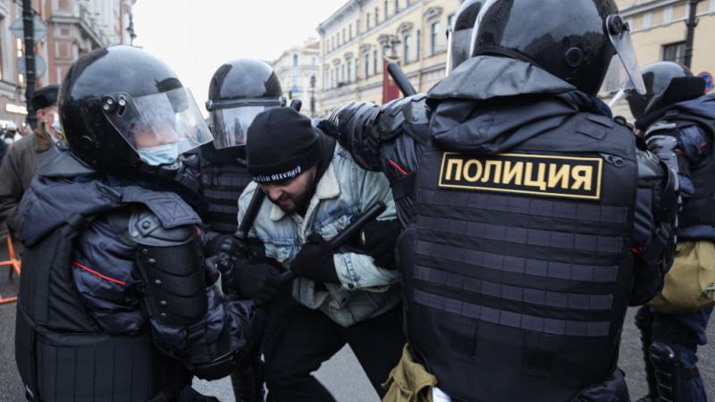 Police detain a protester at a rally supporting Alexei Navalny in St. Petersburg, Russia