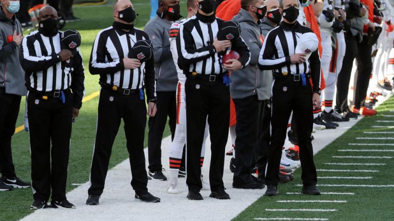 Referees acknowledge the National Anthem at a Browns/Jets game, Dec. 2020