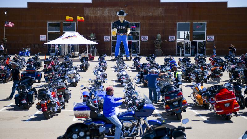 A motorcycle rider looks for parking outside the Full Throttle Saloon during the 80th Annual Sturgis Motorcycle Rally in Sturgis, South Dakota on August 9, 2020.