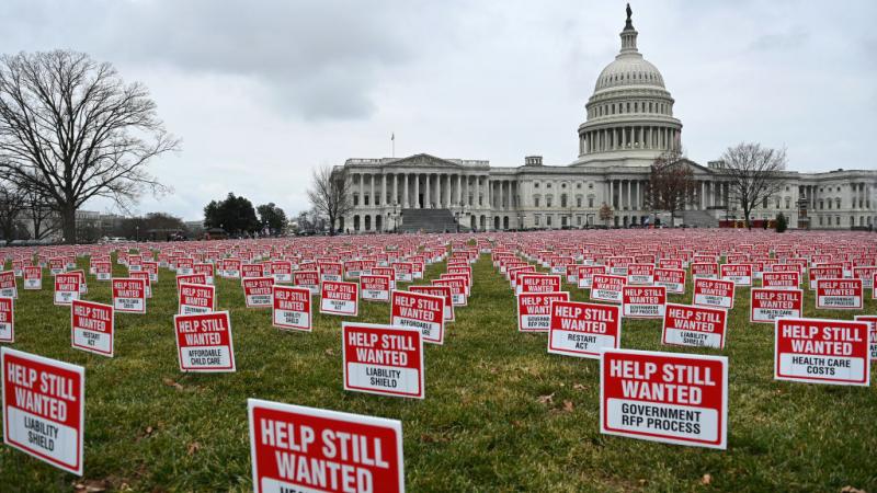 Signs calling for more relief, a second Paycheck Protection Program, and support from elected officials 
