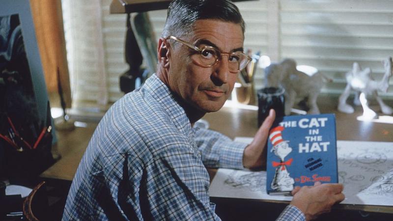 Dr. Seuss sits with his book, 'The Cat in the Hat,' California, 1957