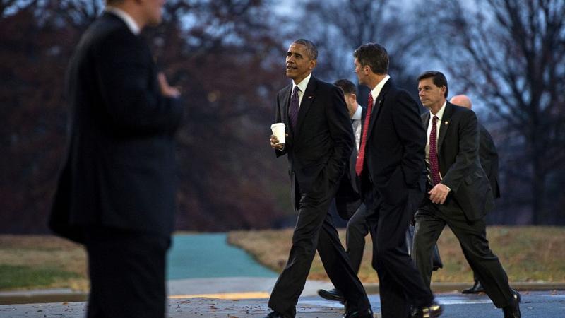 Former President Former President Obama walks with his physician Dr. Ronny Jackson in 2016.