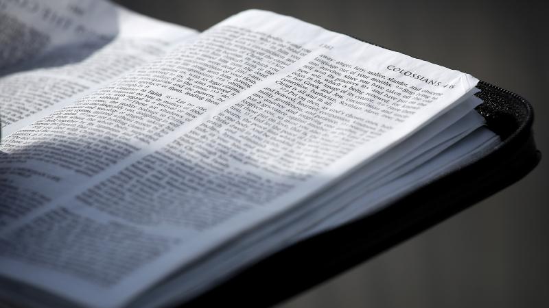 A man reads scripture from the Bible as members of the public wait in line to view the casket of Christian evangelist and Southern Baptist minister Billy Graham as he lies in honor in the U.S. Capitol Rotunda February 28, 2018 in Washington, DC.