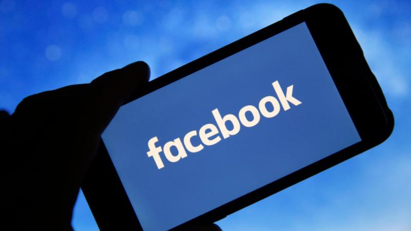 Photo illustration of Facebook logo seen on screen of phone in January 2019 in France