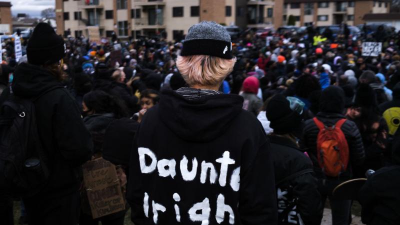 A person wears a hoodie bearing the name of Daunte Wright as protesters gather outside the Brooklyn Center police headquarters