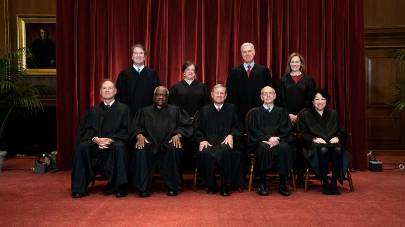 Members of the Supreme Court pose for a group photo at the Supreme Court in Washington, DC on April 23, 2021.