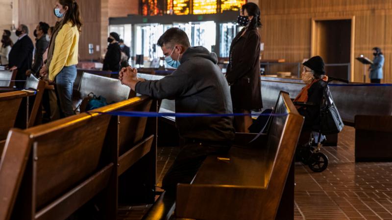 Keith Bergquist prays during an in-church Easter Mass celebration at Cathedral of Saint Mary of the Assumption in San Francisco, California 