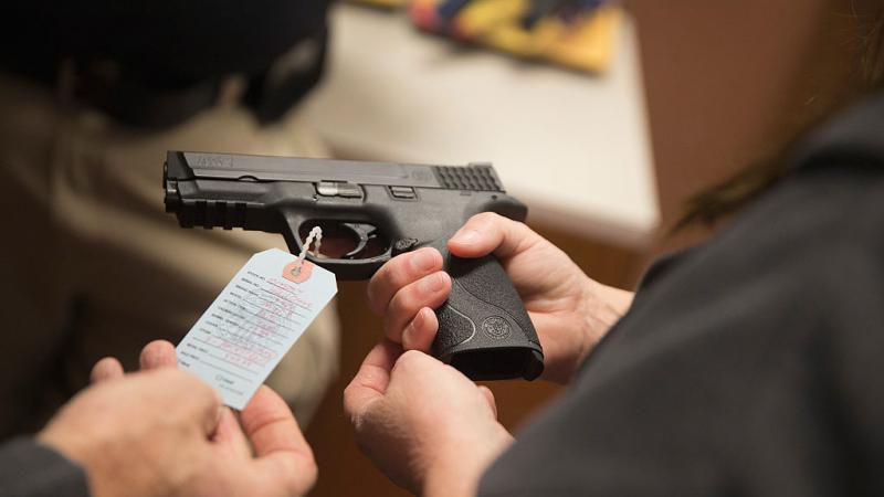 Customers shop for hand gun at Metro Shooting Supplies in Bridgeton, Missouri in 2014